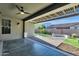 Covered patio with gray-stained concrete, pavers, exterior fan, and view of the block wall fenced-in yard at 2483 E Narrowleaf Dr, Gilbert, AZ 85298