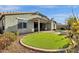 Well-maintained backyard featuring beautiful desert landscaping, covered patio, and synthetic grass at 2483 E Narrowleaf Dr, Gilbert, AZ 85298