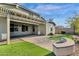 Beautiful backyard featuring a covered patio, pavers, artificial turf, and string lights at 2483 E Narrowleaf Dr, Gilbert, AZ 85298