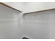 Walk-in closet with white walls and wood closet rods at 2483 E Narrowleaf Dr, Gilbert, AZ 85298