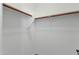 Walk-in closet with white walls and wood closet rods at 2483 E Narrowleaf Dr, Gilbert, AZ 85298