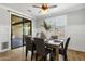 Stylish dining room with wood table, upholstered chairs, wainscoting, and sliding glass door at 2483 E Narrowleaf Dr, Gilbert, AZ 85298