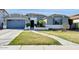 Charming home featuring manicured lawn, an oversized driveway, two-car garage and desert landscaping at 2483 E Narrowleaf Dr, Gilbert, AZ 85298