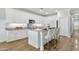 Stylish kitchen with white cabinetry, granite countertops, stainless steel appliances, and a center island with seating at 2483 E Narrowleaf Dr, Gilbert, AZ 85298