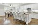 Bright kitchen features white cabinetry, granite countertops, an island with bar seating, and an adjacent dining area at 2483 E Narrowleaf Dr, Gilbert, AZ 85298