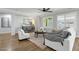 Bright living room with white sofa, chairs, and decorative pillows plus a modern cabinet at 2483 E Narrowleaf Dr, Gilbert, AZ 85298