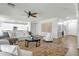 Bright and airy living room featuring hardwood floors, a ceiling fan and an open floor plan at 2483 E Narrowleaf Dr, Gilbert, AZ 85298