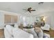 Bright living room with white sofa, chairs, and decorative pillows and modern furniture at 2483 E Narrowleaf Dr, Gilbert, AZ 85298
