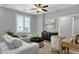 Cozy living room featuring comfortable seating, a ceiling fan, and plenty of natural light at 2483 E Narrowleaf Dr, Gilbert, AZ 85298