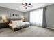 Spacious main bedroom boasts a ceiling fan, a large window, and carpeted floors at 2483 E Narrowleaf Dr, Gilbert, AZ 85298