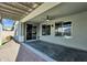 Covered patio with gray-stained concrete, paver walkway, exterior fan, and a view into the kitchen at 2483 E Narrowleaf Dr, Gilbert, AZ 85298