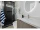 Bathroom featuring a glass shower, round mirror and floating vanity with storage at 2642 N Fiesta St, Scottsdale, AZ 85257