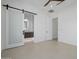 Stylish bedroom with sliding barn door to bathroom with vanity and recessed lighting at 2642 N Fiesta St, Scottsdale, AZ 85257