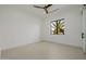Bright bedroom features a modern ceiling fan and a view of an outside palm tree at 2642 N Fiesta St, Scottsdale, AZ 85257