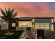 Modern home with drought-resistant landscaping, a sleek front entrance and a contemporary black framed garage at 2642 N Fiesta St, Scottsdale, AZ 85257