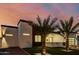 Modern home featuring xeriscaping, a sleek front entrance, and a contemporary black framed garage at 2642 N Fiesta St, Scottsdale, AZ 85257