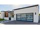 Modern home with a glass garage door and desert landscaping at 2642 N Fiesta St, Scottsdale, AZ 85257