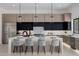 Stunning kitchen features a large island with seating, modern cabinetry, stainless steel appliances, and stylish pendant lighting at 2642 N Fiesta St, Scottsdale, AZ 85257
