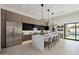 Gourmet kitchen with a spacious island, stainless steel appliances, and direct views of the outdoor pool area at 2642 N Fiesta St, Scottsdale, AZ 85257