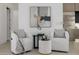 Cozy sitting area with two white armchairs, accent table, and an elegant painting at 2642 N Fiesta St, Scottsdale, AZ 85257