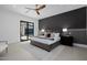 Well-lit primary bedroom featuring an accent wall, access to backyard patio, and tile flooring at 2642 N Fiesta St, Scottsdale, AZ 85257
