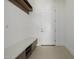 Mudroom with a stone bench and shelving, leading to an entry door at 2642 N Fiesta St, Scottsdale, AZ 85257