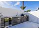 Modern outdoor kitchen with stainless steel appliances and stylish stone accents, perfect for entertaining at 2642 N Fiesta St, Scottsdale, AZ 85257