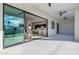 Spacious patio with sleek tile flooring, ceiling fans, and an open view into the modern kitchen and living space at 2642 N Fiesta St, Scottsdale, AZ 85257