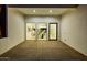 Spacious back patio with large glass doors offering views of a dining room with a fireplace and modern decor at 2642 N Fiesta St, Scottsdale, AZ 85257