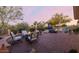 Spacious backyard with mature trees, comfortable seating, and a cozy fire pit at 32215 N 16Th Ave, Phoenix, AZ 85085