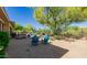 Scenic backyard featuring a desert landscape, mature tree, and comfortable seating area at 32215 N 16Th Ave, Phoenix, AZ 85085