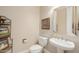 Cozy powder room featuring neutral colors, a pedestal sink, and framed art at 32215 N 16Th Ave, Phoenix, AZ 85085