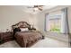 Cozy bedroom with ceiling fan, window view, and dark wood furniture at 32215 N 16Th Ave, Phoenix, AZ 85085