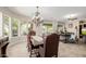 Elegant dining room featuring a decorative chandelier and large windows with outdoor views at 32215 N 16Th Ave, Phoenix, AZ 85085