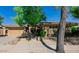 Inviting home exterior with stone accents, mature trees, and well-maintained landscaping at 32215 N 16Th Ave, Phoenix, AZ 85085