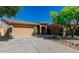 Charming home exterior with three-car garage, stone accents, and desert landscaping at 32215 N 16Th Ave, Phoenix, AZ 85085