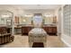 Luxurious bathroom with dual vanities, a center tub, and elegant lighting fixtures at 32215 N 16Th Ave, Phoenix, AZ 85085