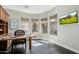 Stylish home office with dark wood floors, built-in cabinets, and multiple windows at 32215 N 16Th Ave, Phoenix, AZ 85085