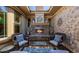 Relaxing outdoor patio area with stone fireplace, comfortable seating, and elegant decor at 32215 N 16Th Ave, Phoenix, AZ 85085