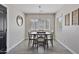Cozy dining room featuring modern table set with seating for four, a minimalist light fixture, and window at 3516 E Earll Dr, Phoenix, AZ 85018