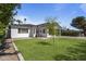 Charming single-story home with green lawn, inviting curb appeal, and a welcoming front entrance at 3516 E Earll Dr, Phoenix, AZ 85018
