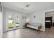Bright living room with wood-look tile floors, light gray walls, and access to a landscaped yard at 3516 E Earll Dr, Phoenix, AZ 85018