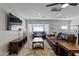 Living room with brown couches, neutral walls, modern lighting, and mounted TV at 3516 E Earll Dr, Phoenix, AZ 85018