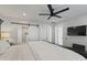 Bright main bedroom with ceiling fan, sliding barn door, and access to en suite bathroom at 3516 E Earll Dr, Phoenix, AZ 85018