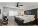 Cozy bedroom features a large bed, ceiling fan, wood floors, and lots of natural light at 3516 E Earll Dr, Phoenix, AZ 85018