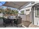 Covered patio featuring an outdoor dining table, chairs, and string lights at 3516 E Earll Dr, Phoenix, AZ 85018
