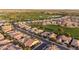 Gorgeous aerial view of neighborhood homes backing up to golf course and manicured green spaces at 37148 N Stoneware Dr, Queen Creek, AZ 85140