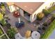 Aerial shot of backyard with patio, lounge chairs, dining area, water feature, and mature landscaping at 37148 N Stoneware Dr, Queen Creek, AZ 85140