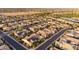 Expansive aerial view of a community with beautiful homes, desert landscape, and solar panels at 37148 N Stoneware Dr, Queen Creek, AZ 85140