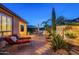 Expansive backyard with multiple outdoor seating and dining areas, water feature and manicured landscaping at 37148 N Stoneware Dr, Queen Creek, AZ 85140